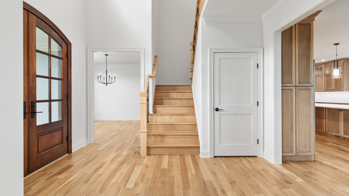 Entryway with stairs and closet, dining room, and kitchen