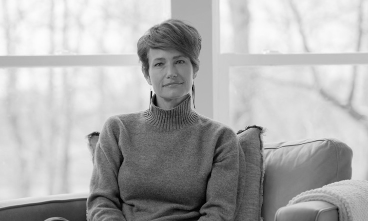 woman sitting in chair smiling at camera