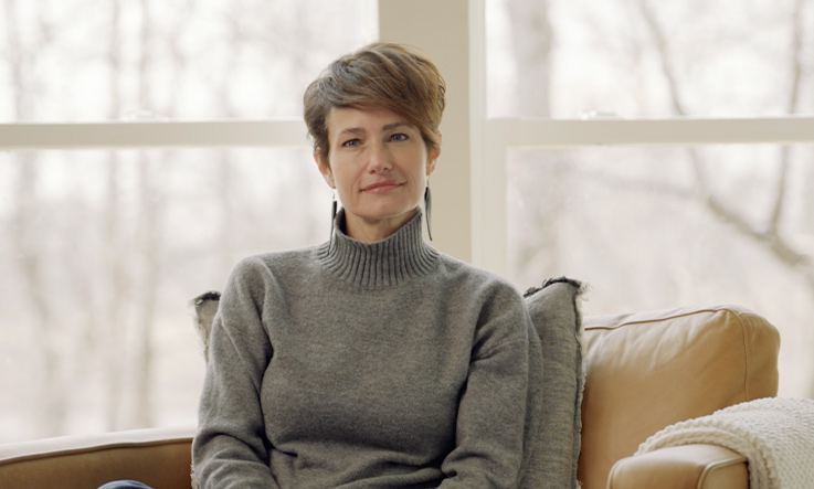 woman sitting in chair smiling at camera