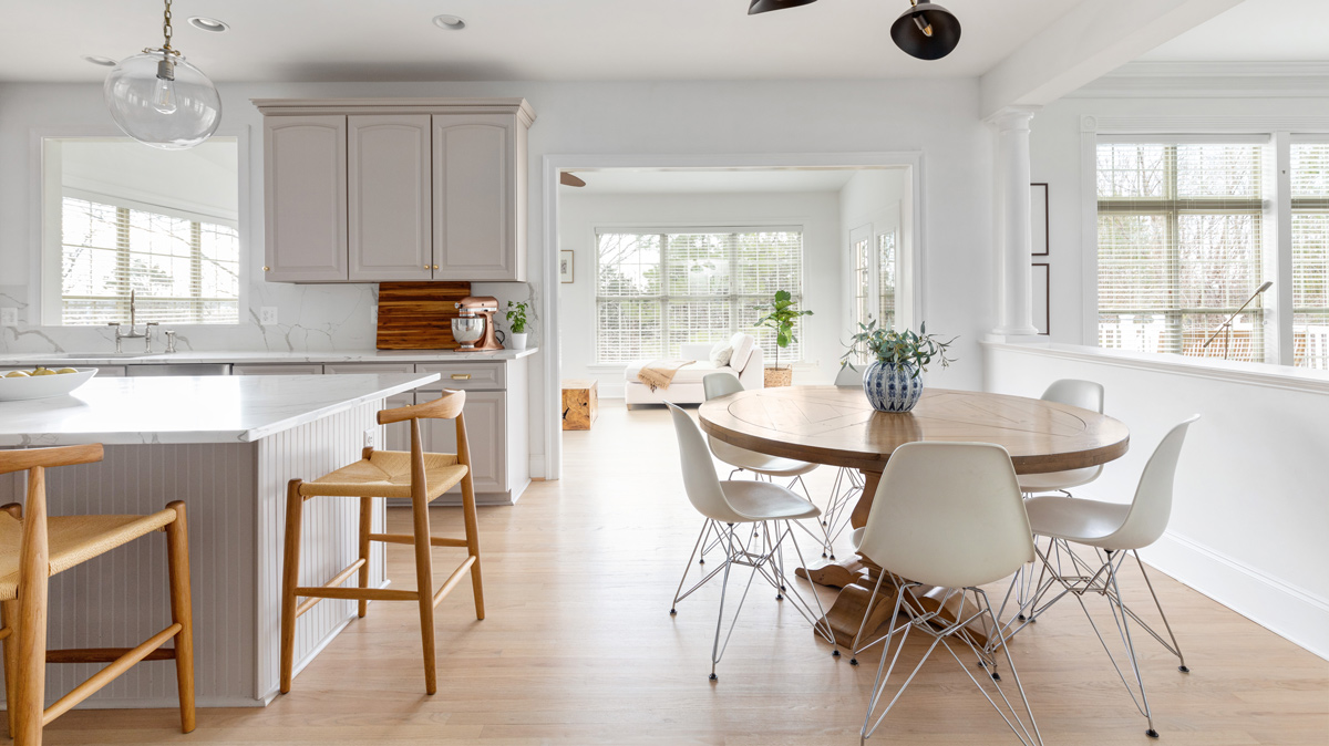 crispy white kitchen and dining room leading into the living room