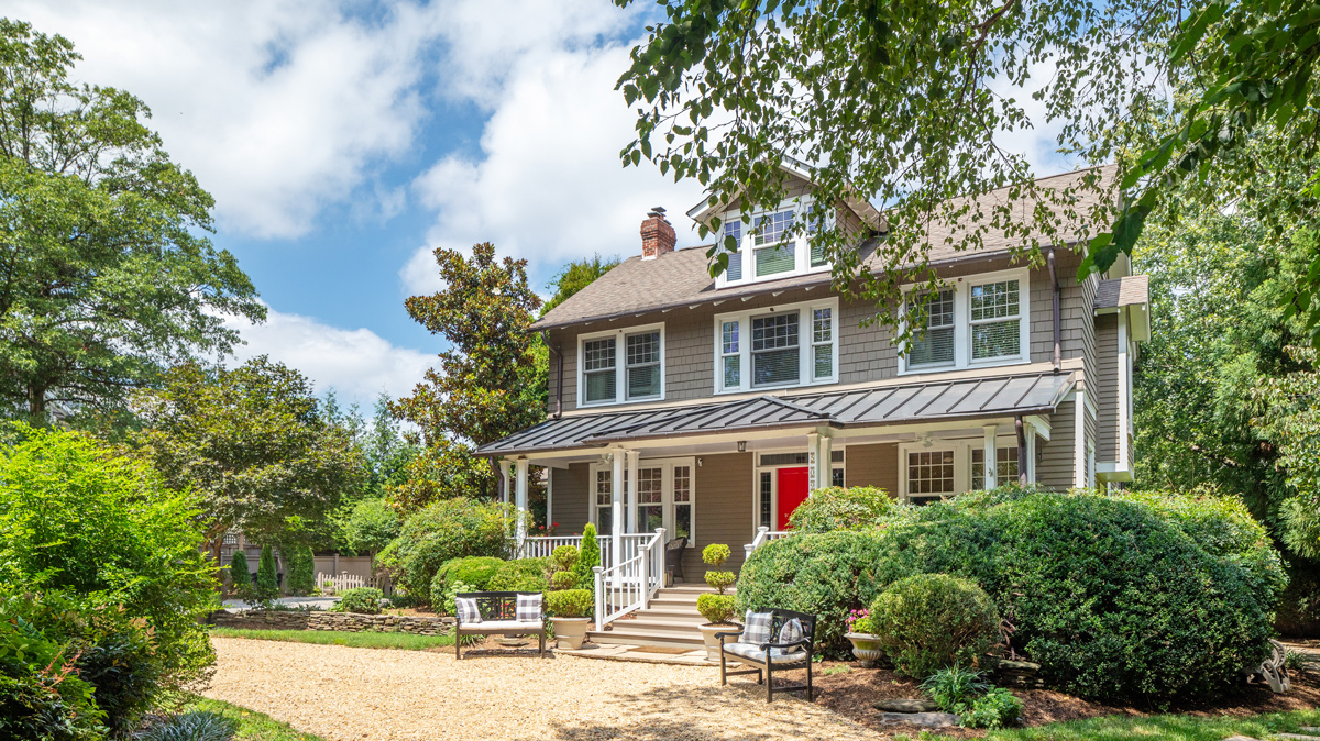 front of a 3 story home in a rural setting