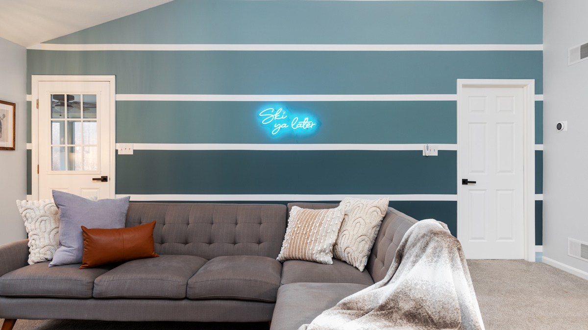 living room with neon sign that says 
