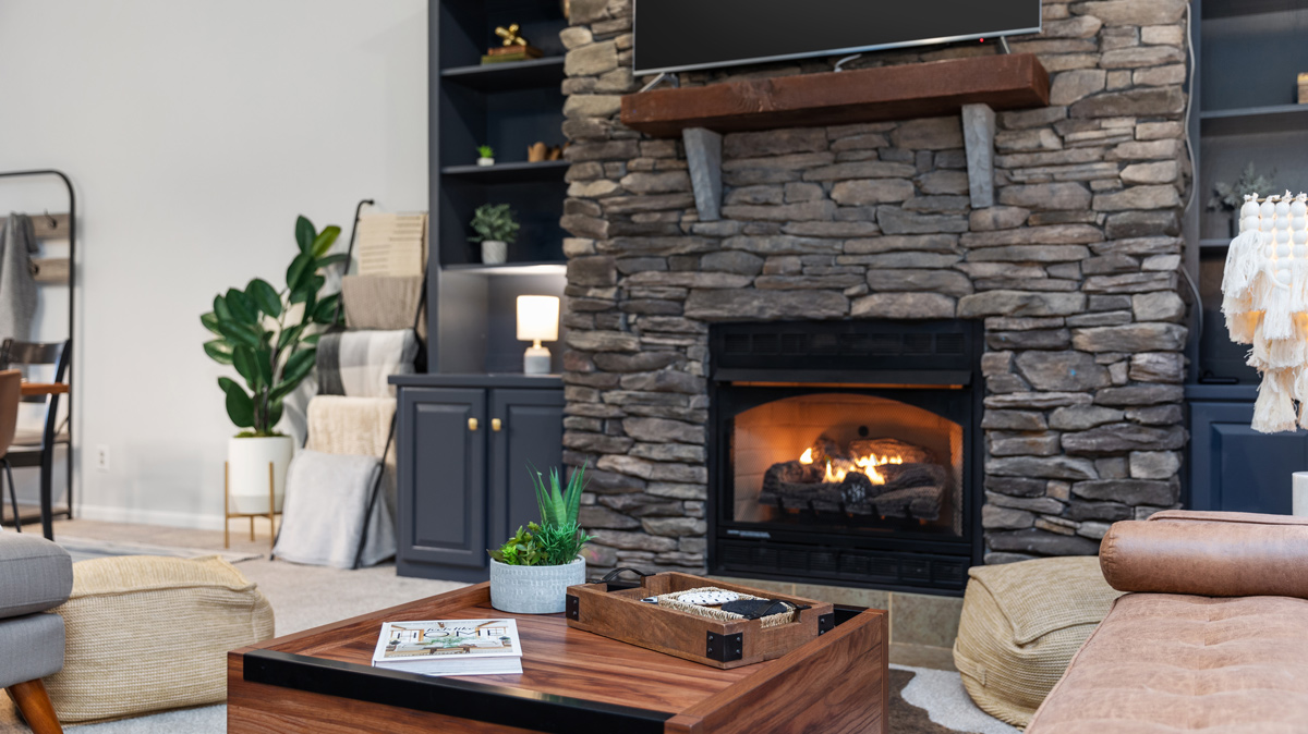 living room with fireplace with built in shelving