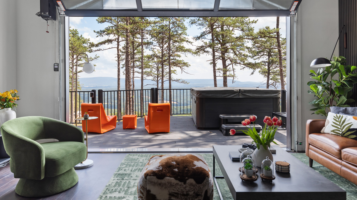 living room with garage door opening onto back deck that overlooks the mountains
