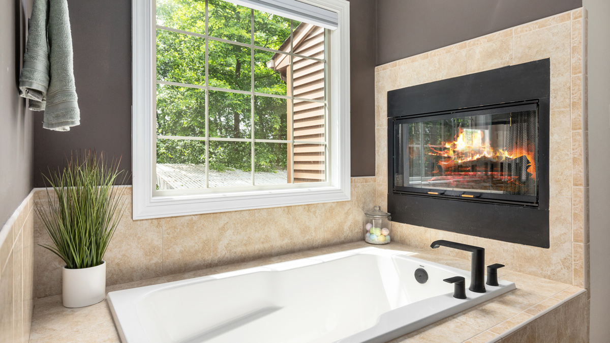 master bathroom soaking tub with electric fireplace