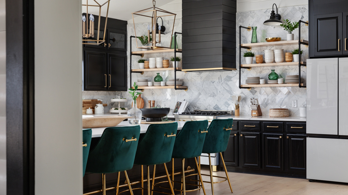 black and white kitchen with open shelving, gas range, and large island with green velvet stools