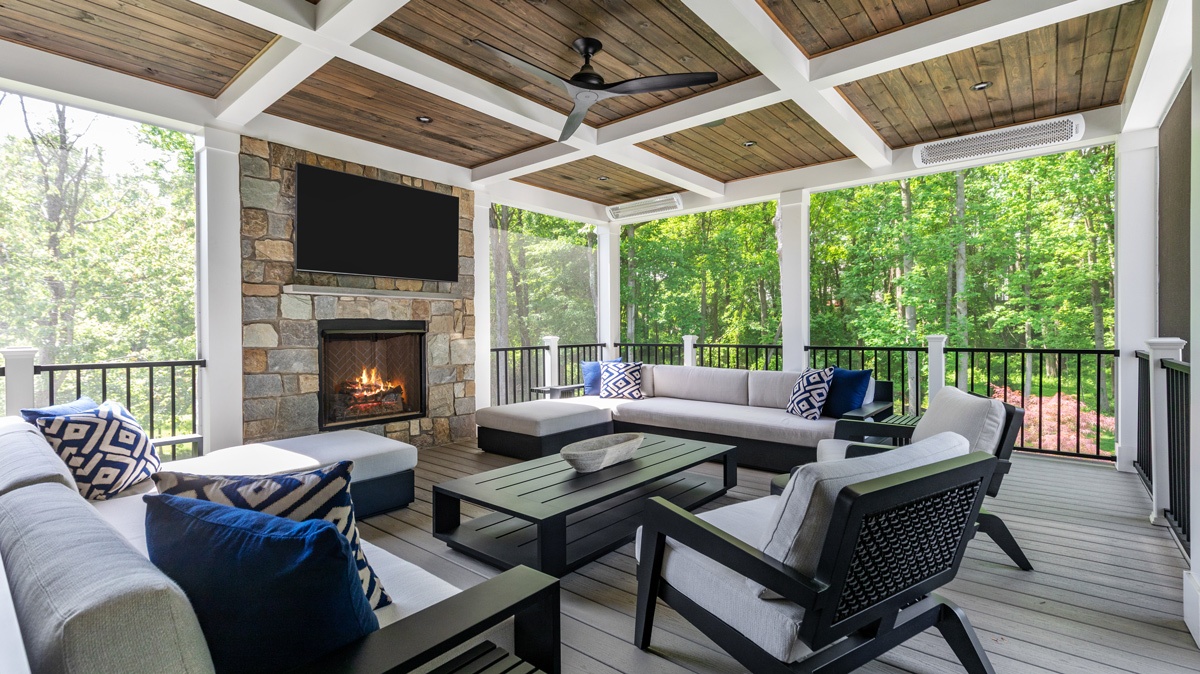 outdoor porch seating area with fireplace and mounted tv