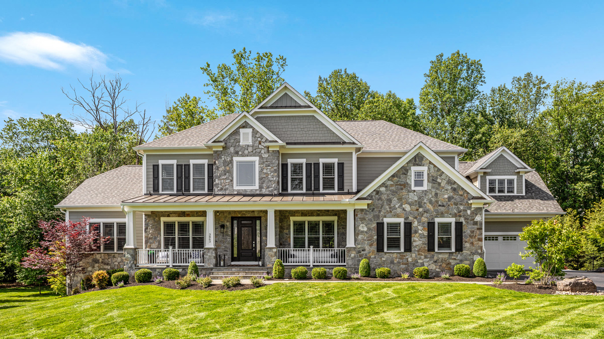 front view of a 2 story residential home with beautiful stone exterior