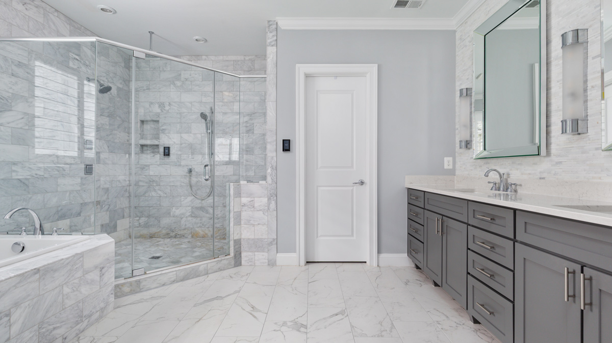 master bathroom with standing shower, bathtub and double vanity