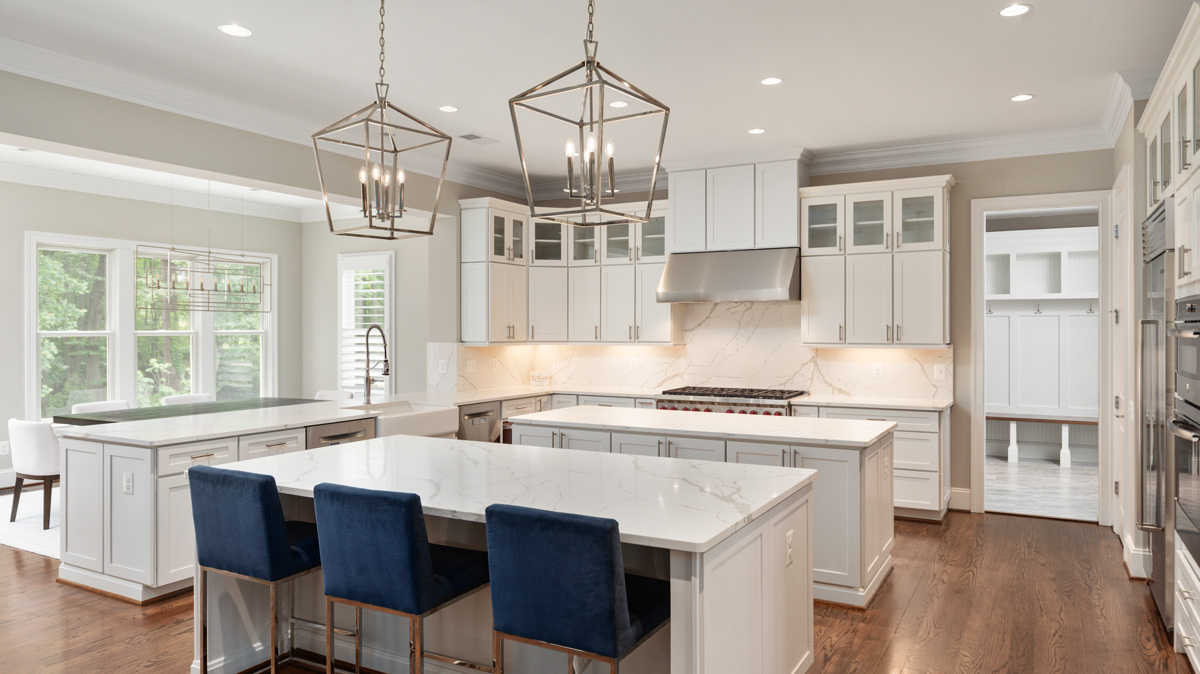 Kitchen with double island, gas range, and