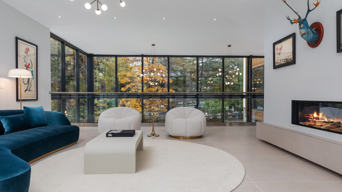 Dr. Seuss themed living room with a wall of windows overlooking the woods