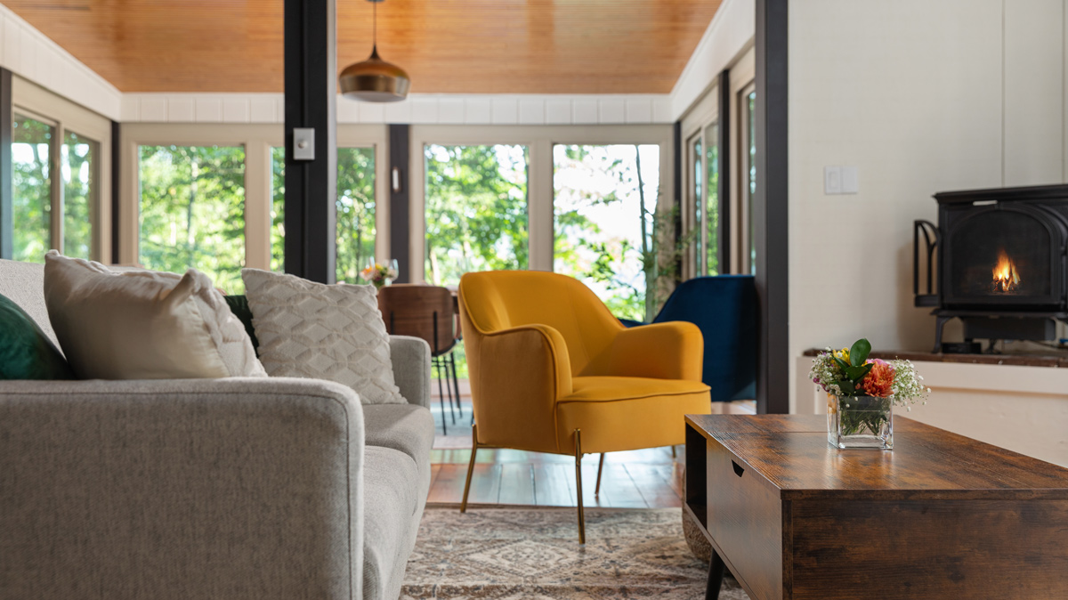 living room with wood burner and mustard yellow chair