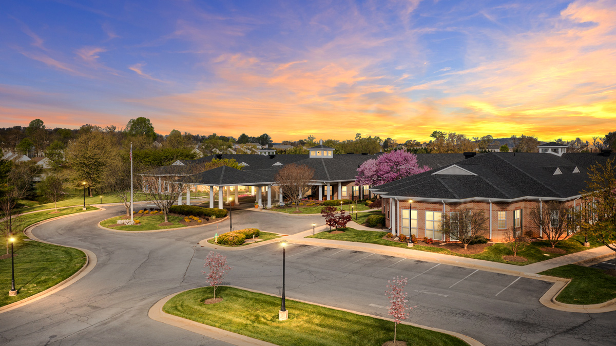 Aerial view of Willow Springs building and parking lot with trees in bloom
